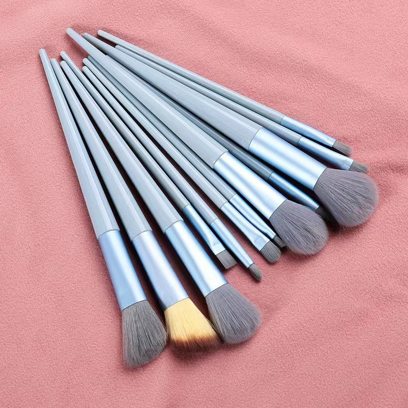 A set of thirteen makeup brushes
